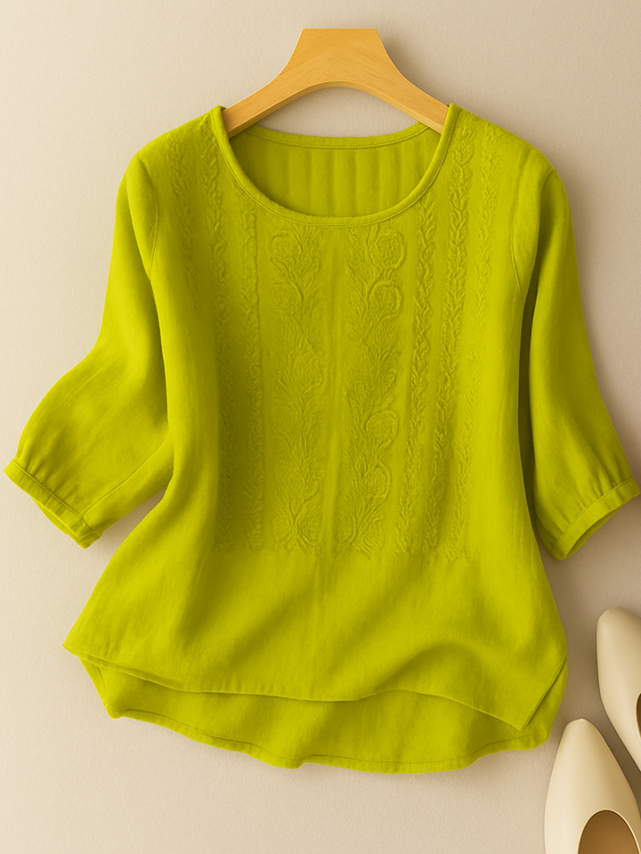 Embroidered women's relaxed fit blouse with a round neck and three-quarter sleeves, ideal for versatile spring casual wear.