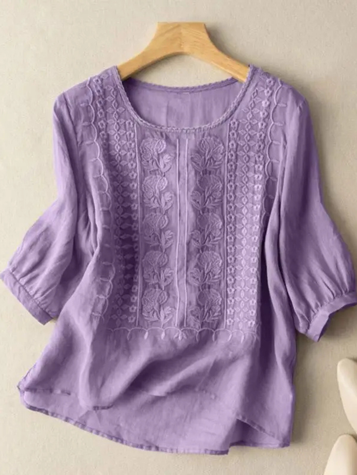 Stylish women's embroidered relaxed fit blouse, three-quarter sleeves, and round neck for comfortable spring fashion.