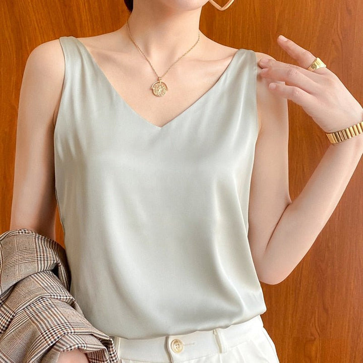 Close-up of the luxurious draped satin fabric on a women's relaxed fit V-neck tank top.