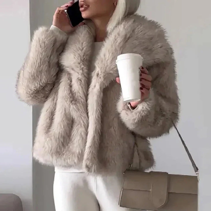 Close-up of a stylish women's faux fur jacket, highlighting its soft texture and relaxed fit for winter.