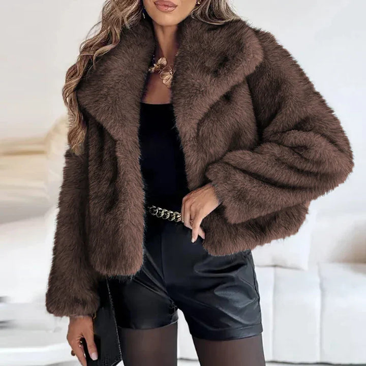 Fashionable woman wearing a cozy, elegant relaxed fit faux fur jacket, ideal for winter outerwear.