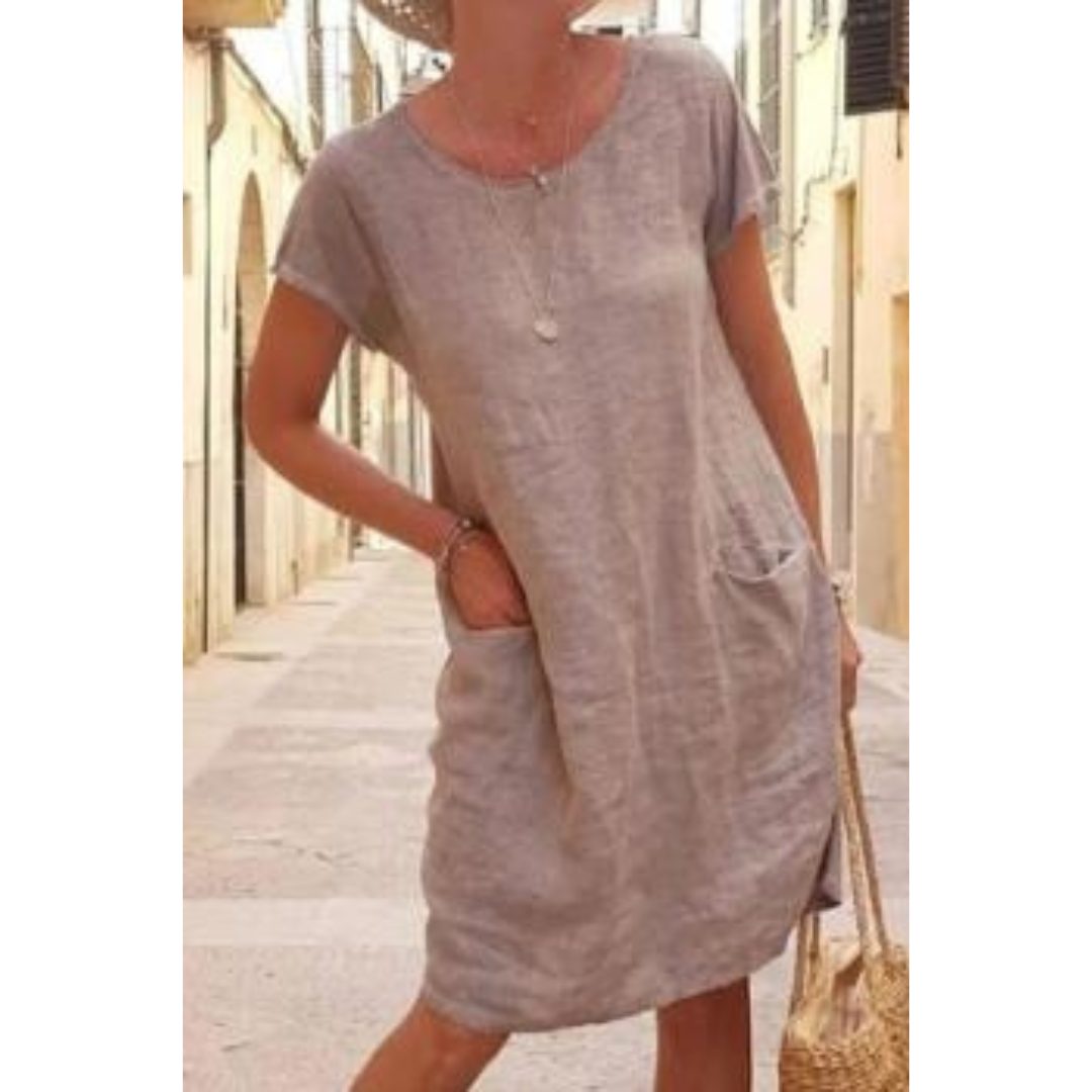 Women's relaxed fit knee-length t-shirt dress with practical pockets, ideal for casual summer wear.