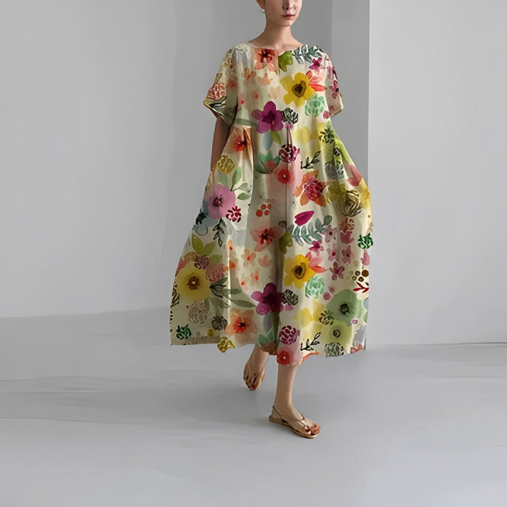 Detailed image of the hemline of a women's relaxed floral print midi dress, rich in color.