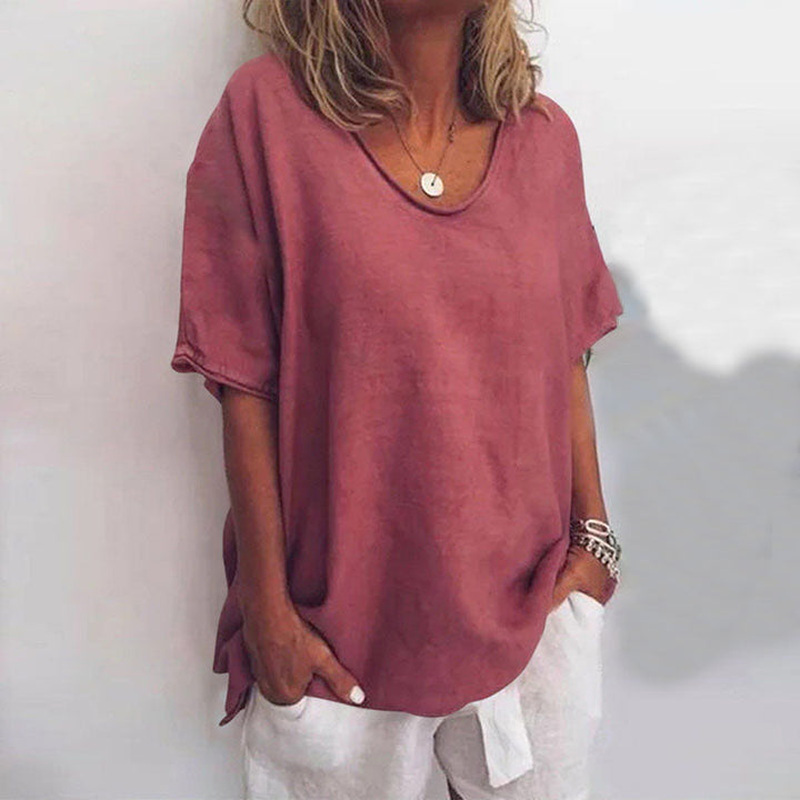 Ladies' drop shoulder V-neck blouse with elbow sleeves. Relaxed fit for everyday comfort, ideal for summer fashion.