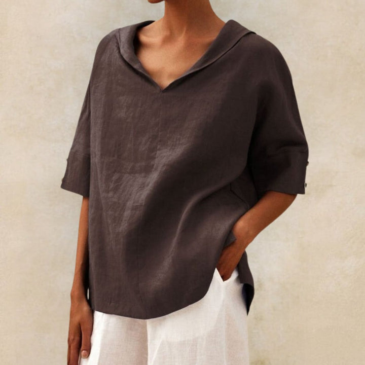 Detailed shot of the V-neckline on a women's spring casual top, emphasizing fabric texture