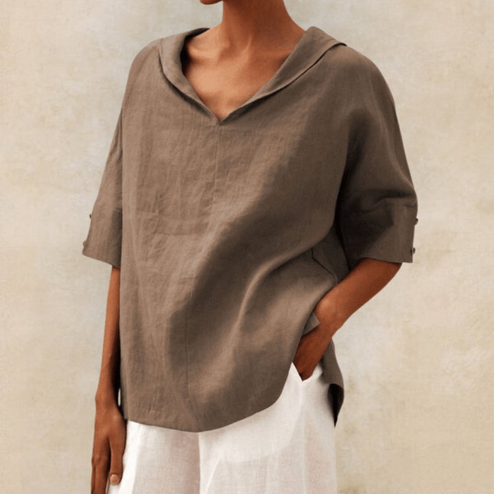 Comfortable oversized V-neck tunic top for women. Relaxed fit short sleeve blouse, ideal for casual everyday wear.