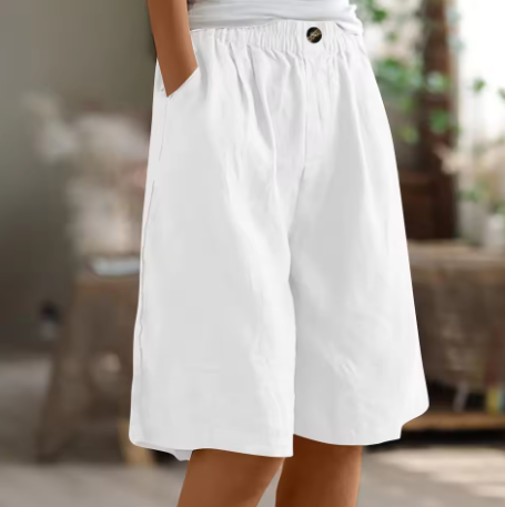 Model wearing women's relaxed wide leg Bermuda shorts, demonstrating their flowy fit and knee-length design.