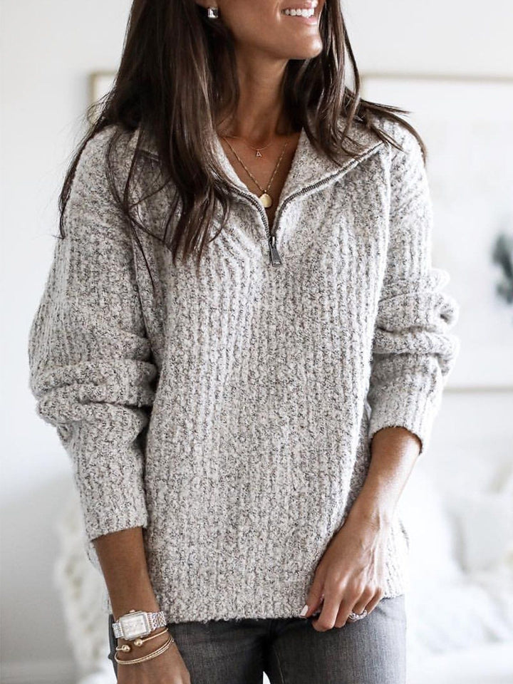 Close-up of a charcoal women's ribbed zip-up sweater, highlighting the soft knit texture