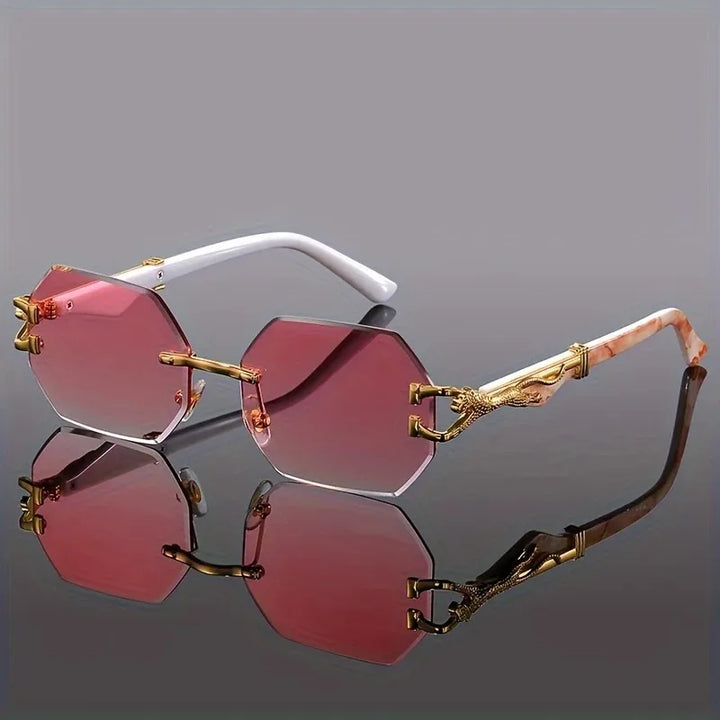 Sculptural women's rimless geometric sunglasses with prominent gold panther. Perfect luxury eyewear.