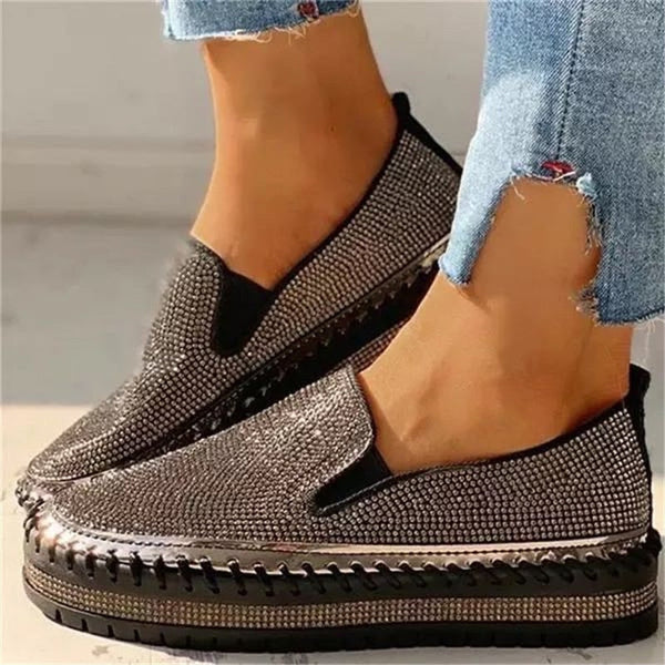 Women's shimmering slip-on shoes, sparkling with glitter for effortless glamour. Perfect comfortable flats for party or casual wear.