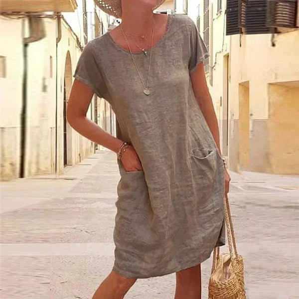 Summer-ready women's short sleeve midi dress with convenient pockets. Ideal for comfortable, casual, and versatile everyday style.