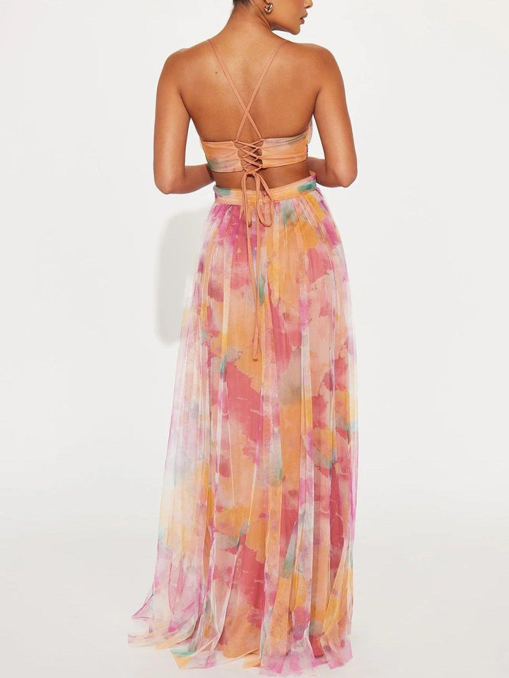 Vibrant floral print sleeveless maxi dress for women. Features a chic v-neck and adjustable tie waist.