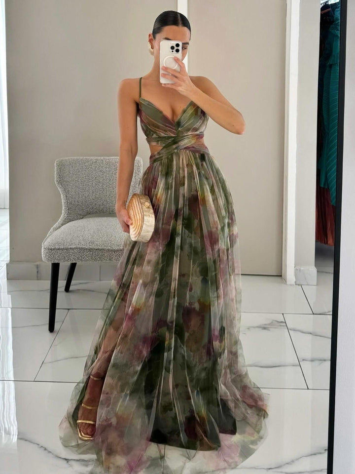 Beautiful women's sleeveless floral print maxi dress. Features a V-neckline and a stylish tie-waist detail.