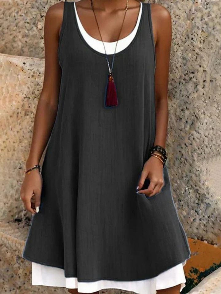 Women's sleeveless scoop-neck A-line midi dress with two layers, perfect for casual summer elegance.