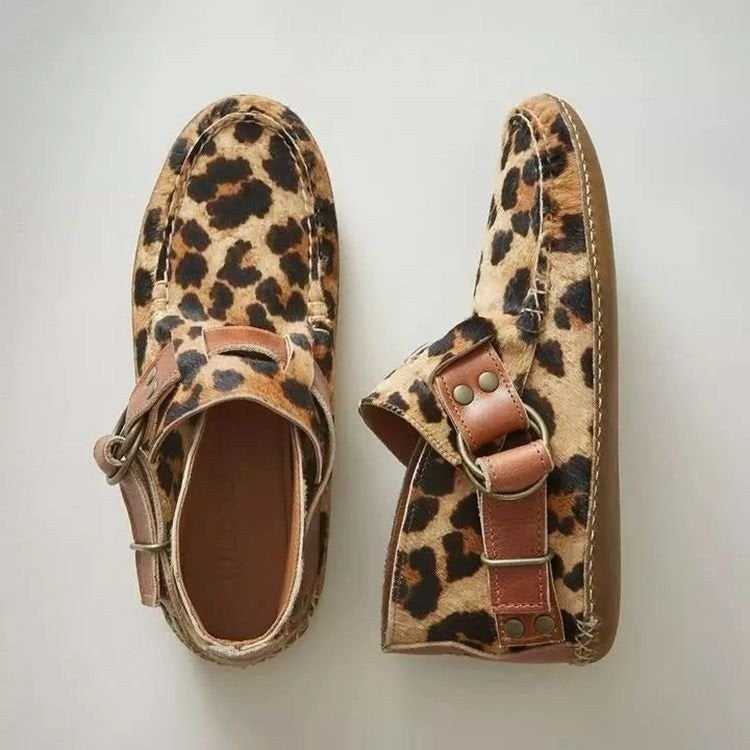 Overhead view of women's comfortable slip-on shoes, featuring a fun artistic cat design on a light background.