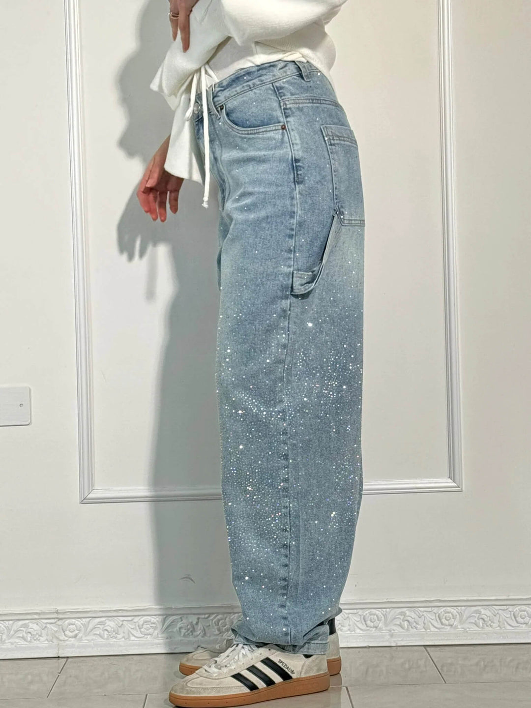 Close-up of the fabric detail on women's high-waisted wide leg flowy pants for spring fashion.