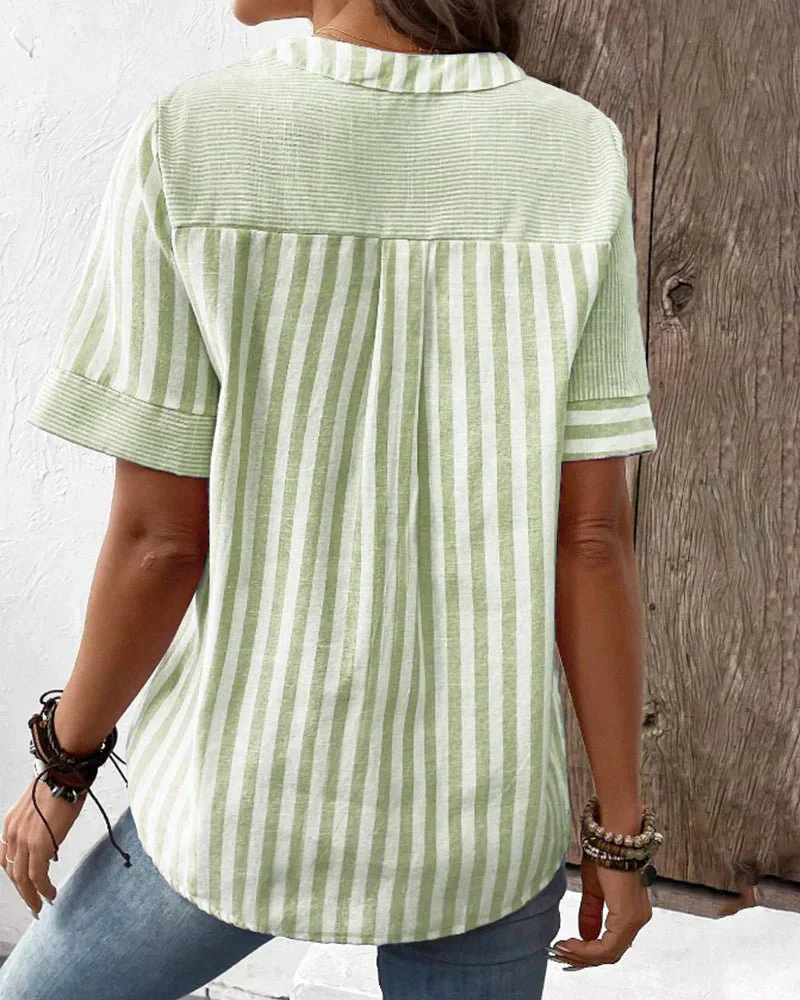 Chic ladies' short sleeve blouse with a unique striped colorblock pattern & functional half-button.