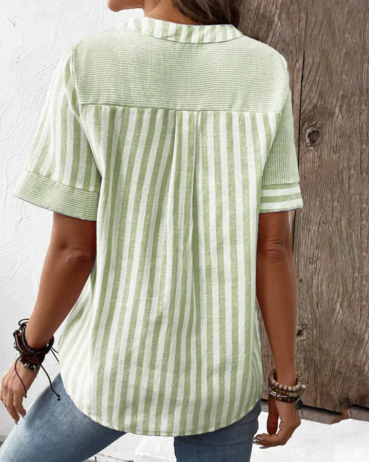 Chic ladies' short sleeve blouse with a unique striped colorblock pattern & functional half-button.