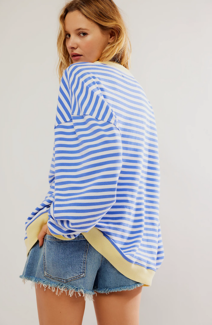 Front view of a women's striped knit sweater, emphasizing the crewneck design.