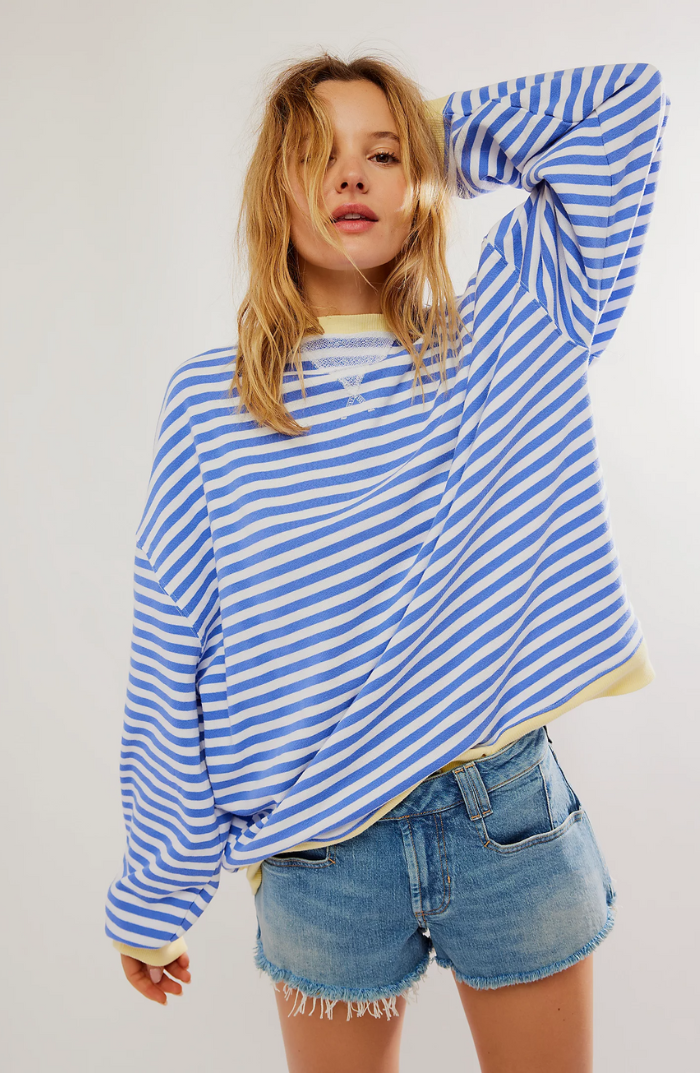 Close-up of a women's knit crewneck sweater with classic stripes and long sleeves.