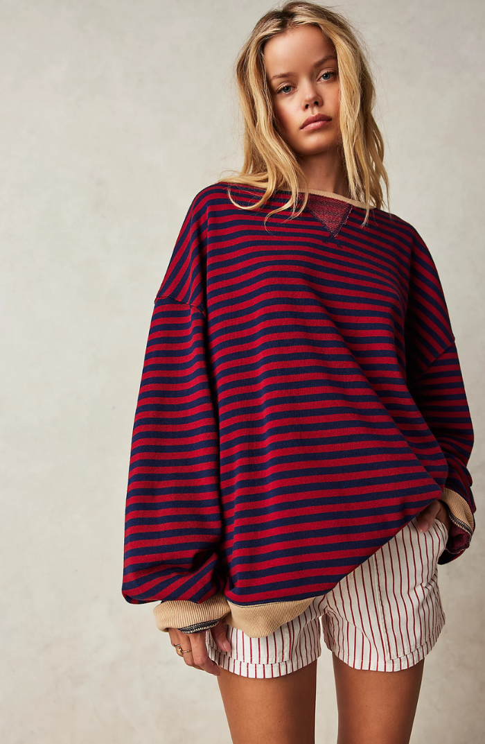Soft knit women's long sleeve striped sweater, a staple for spring fashion.