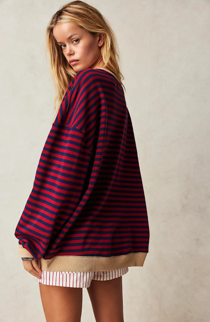 Stylish women's crewneck sweater featuring a timeless striped pattern.