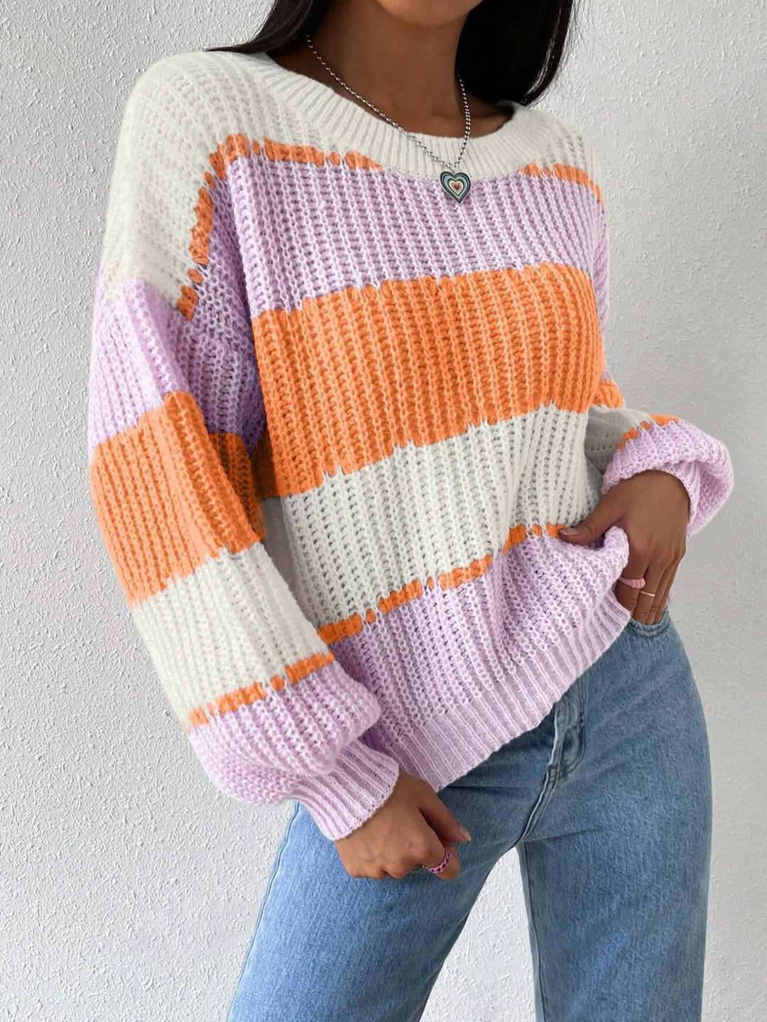 Model wearing a cozy striped knit pullover, perfect for casual autumn outfits
