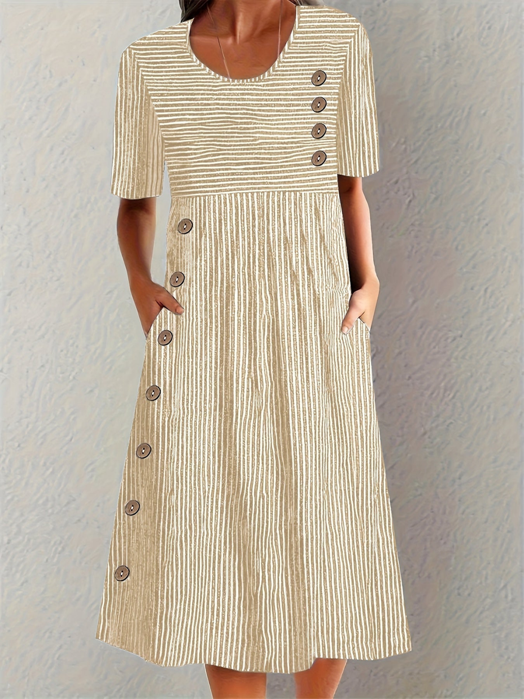 Elegant women's striped midi dress with delicate button details, convenient pockets, and a comfortable design.