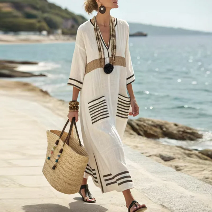 Versatile women's striped kaftan dress, a maxi resort wear essential for casual summer & beach days.