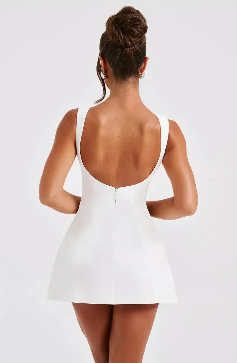 Sleeveless women's fit & flare mini dress, featuring a sophisticated boat neck and structured modern style.