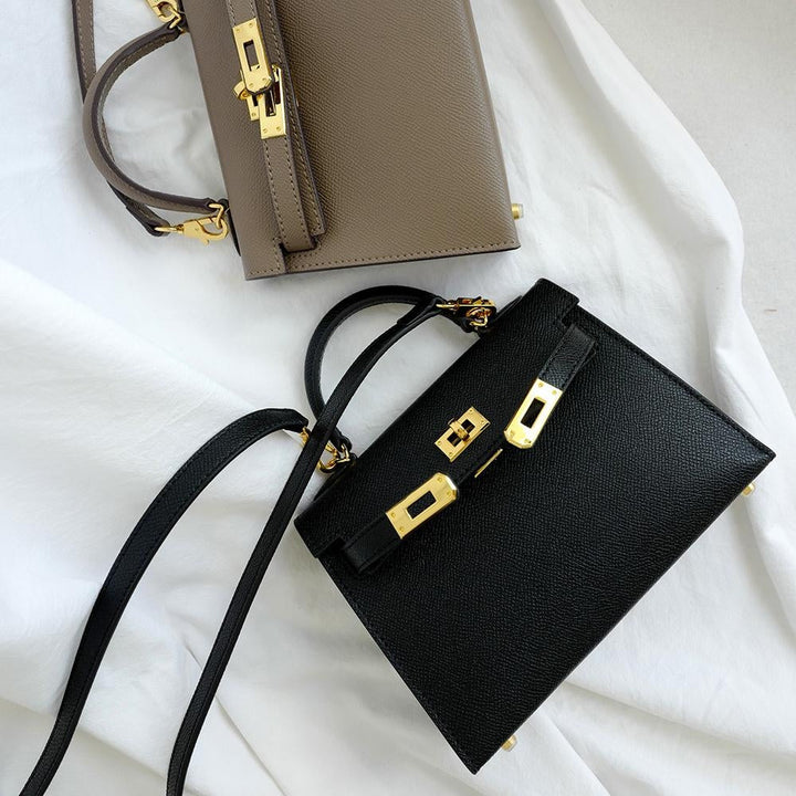Chic brown everyday women's top handle crossbody bag with a sophisticated turn lock and adjustable strap.