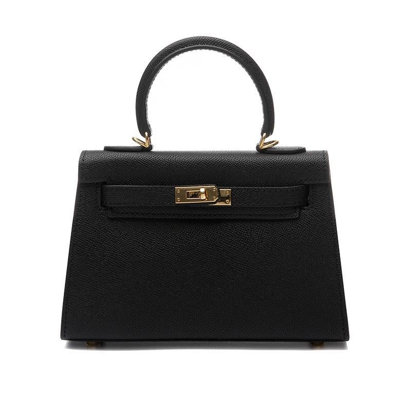 Elegant black women's handbag, a top handle crossbody with a distinctive turn lock and sleek design.