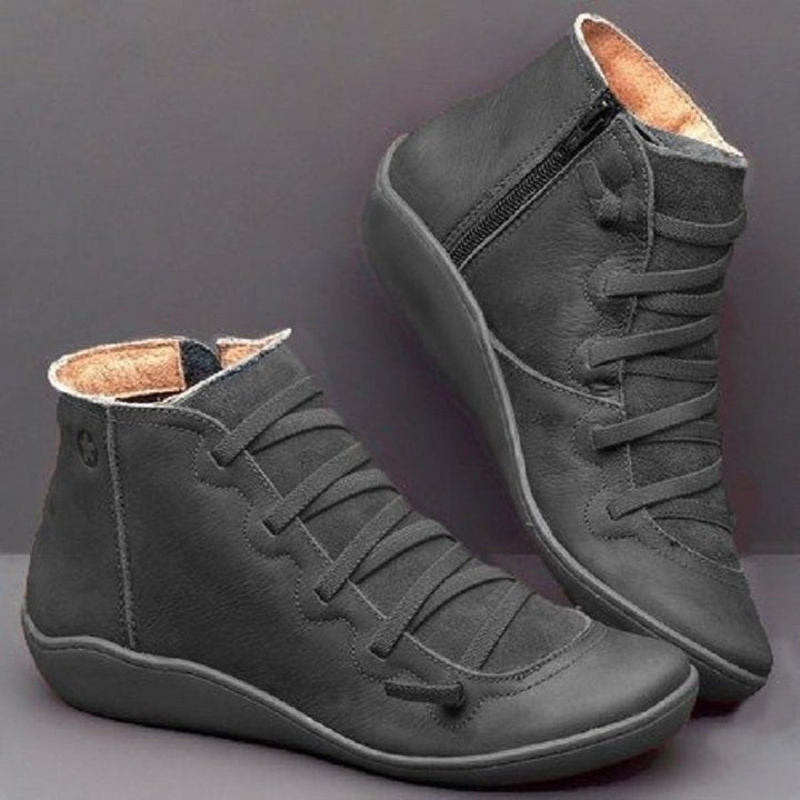 Women's sleek winter boots: lace-up and zip-up ankle style for warmth and trendsetting fashion.