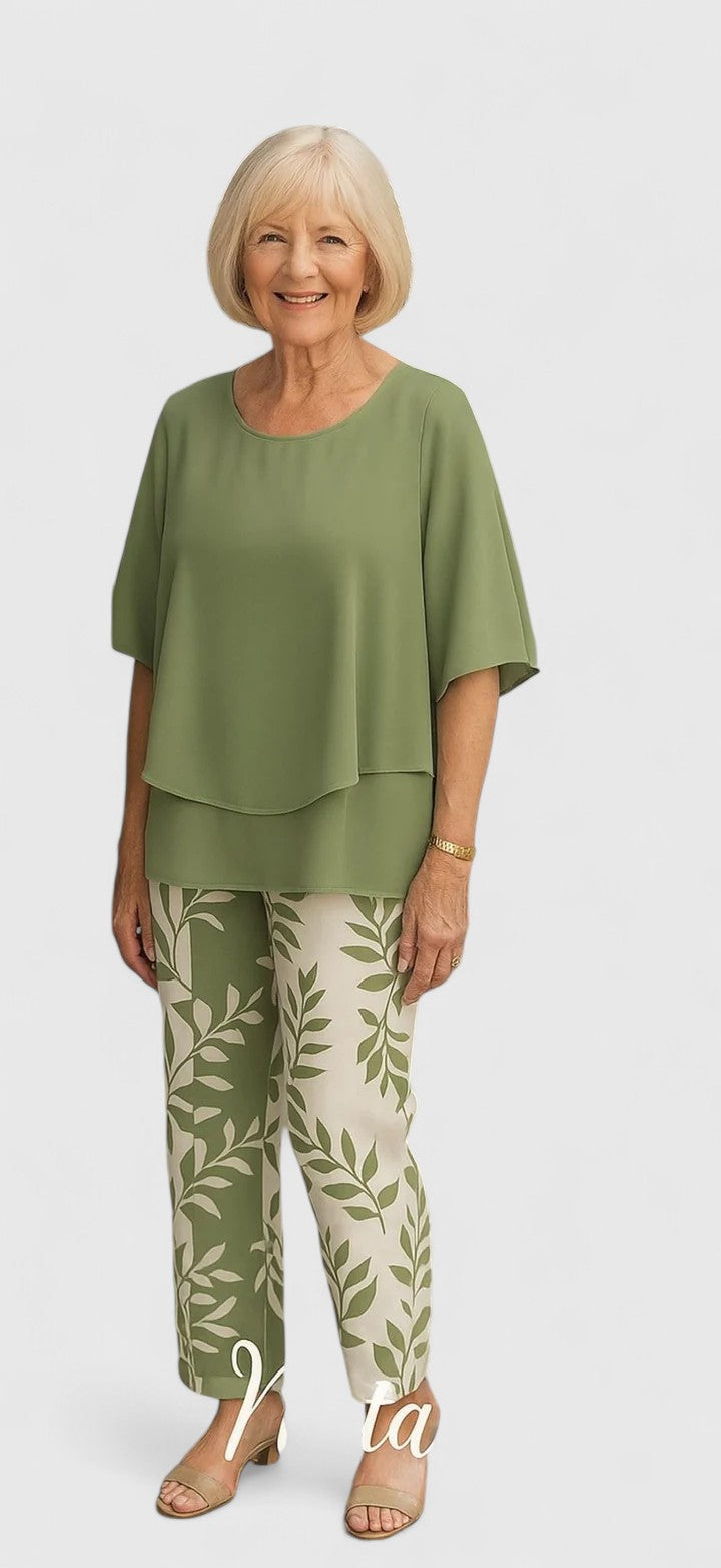 Modern women's casual outfit with a short-sleeve top and fashionable, detailed printed pants for a stylish look.