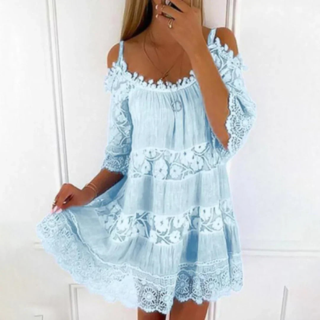 Loose-fit women's mini dress, perfect for spring/summer, with intricate embroidery, crochet details & cold shoulders.
