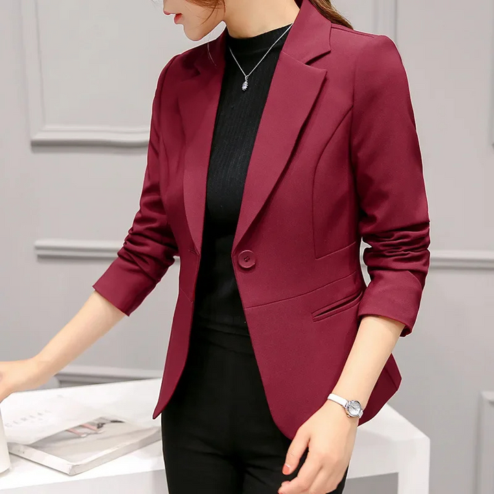 Side profile of a women's slim fit blazer, showing tailored waist and clean lines