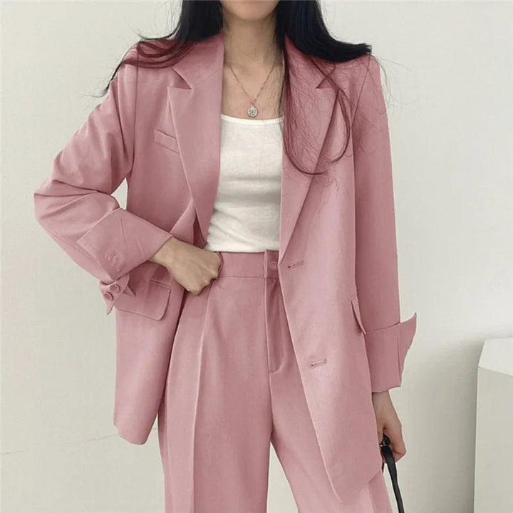 Women's tailored suit set with a long, elegant blazer and matching trousers, perfect for business attire.