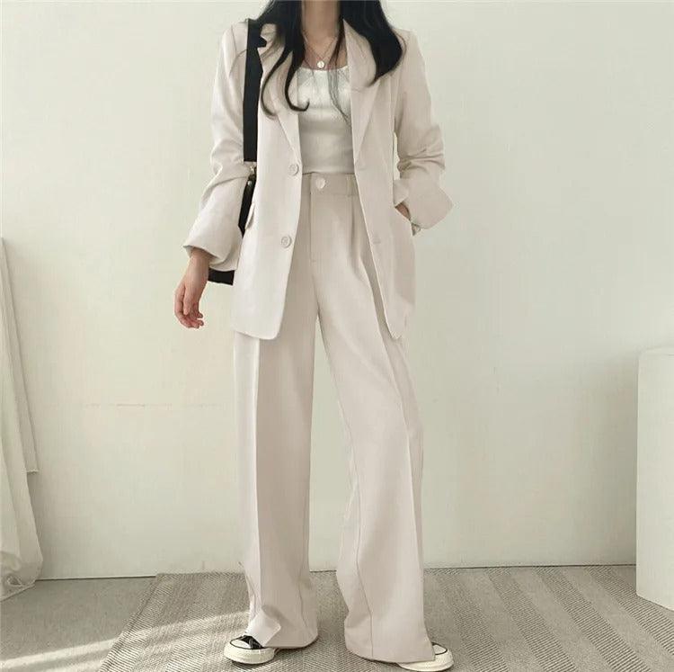 Women's formal wear: a tailored suit with a long blazer, offering a polished professional look.