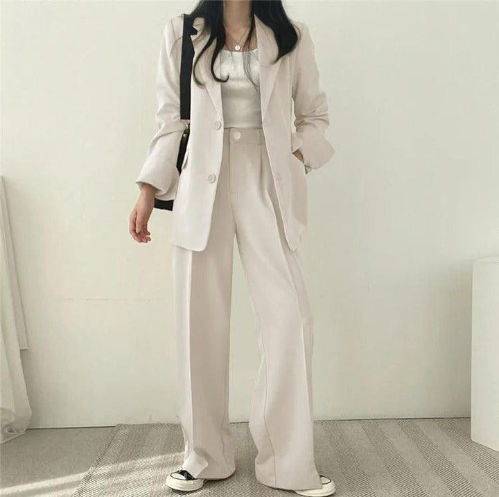 Women's formal wear: a tailored suit with a long blazer, offering a polished professional look.