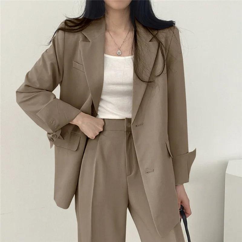 Versatile women's suit set, including a long blazer and tailored trousers, for multiple professional settings.