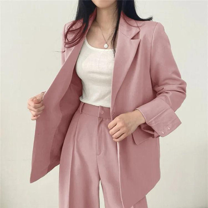 Professional women's suit featuring a sophisticated long blazer and tailored trousers, ideal for workwear.