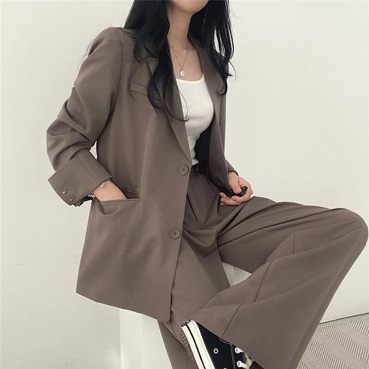 Luxury women's tailored suit with a long blazer, offering premium style and sophisticated appeal.