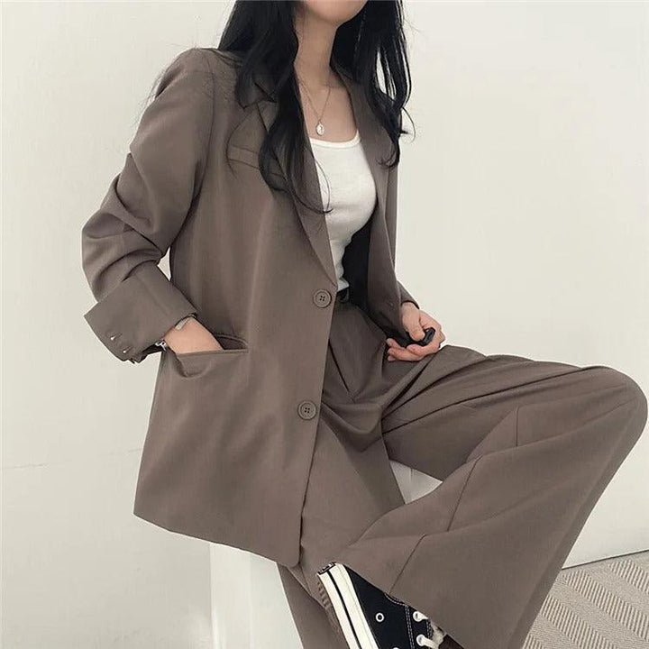 Luxury women's tailored suit with a long blazer, offering premium style and sophisticated appeal.