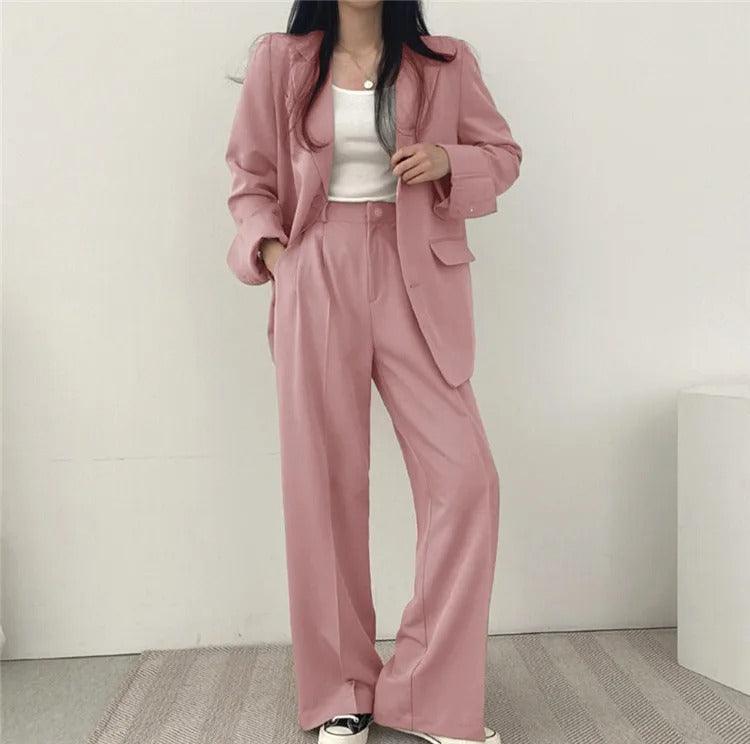 Stylish women's trouser set with a long, structured blazer, suitable for formal occasions.