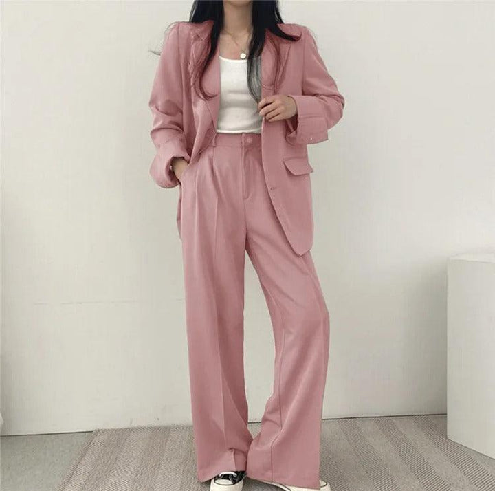 Stylish women's trouser set with a long, structured blazer, suitable for formal occasions.