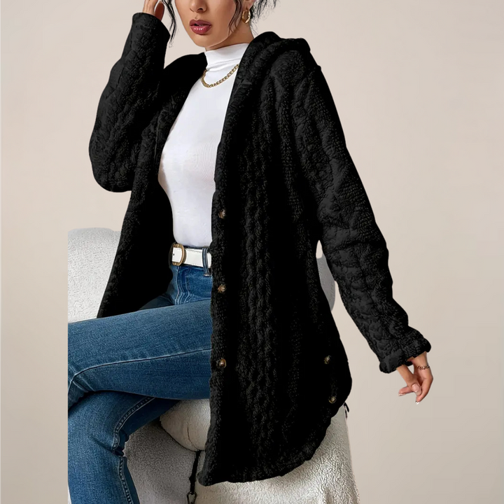 Close-up of the textured knit fabric on a women's long hooded cardigan, showing detail
