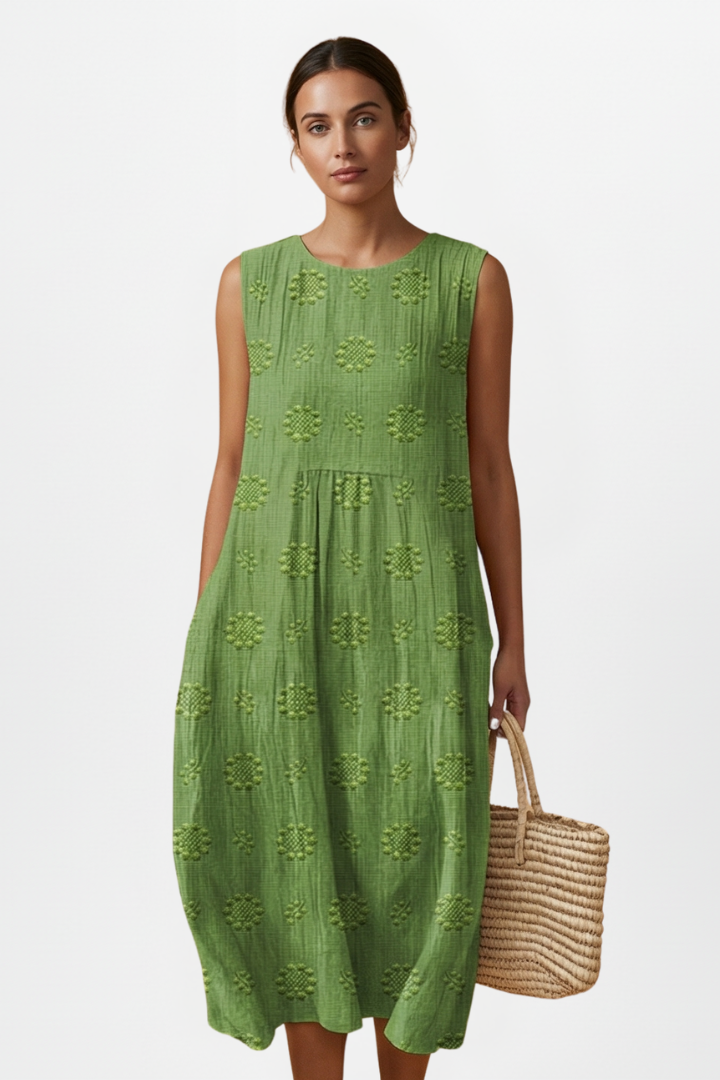 Effortlessly elegant women's textured sleeveless midi dress, round neck, with functional pockets.
