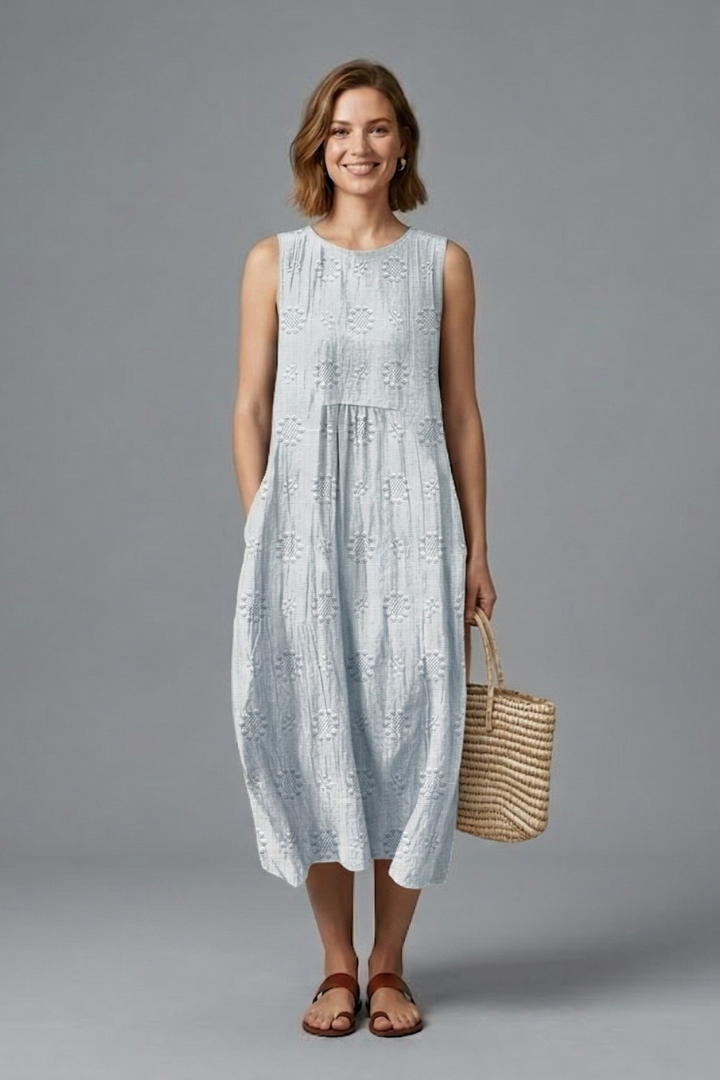 Woman in a relaxed fit textured sleeveless midi dress with pockets, perfect for comfortable everyday.