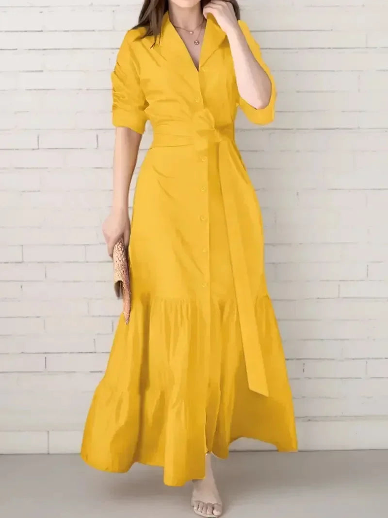 Stylish women's tiered maxi shirt dress. Features a tie waist, long sleeves, and button-down front for an elegant look.