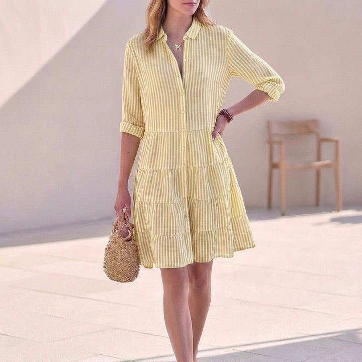 Stylish women's tiered mini shirt dress with button-down details. V-neck, 3/4 sleeves. Great for spring/summer.
